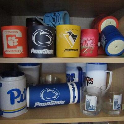 Cabinet Full of Mostly Sports Related Drinkware and Accessories