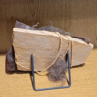Lot 6: Original Artwork (Stone, leather, Feather bound in Jute Twine with Metal Stand)