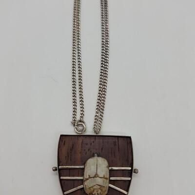 Lot J32: Scarab pendant mounted on wood and silver base