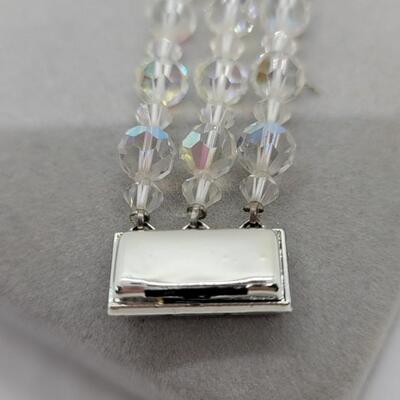 Lot J34: Aurora Borealis Austrian crystal, single strand necklace and triple strand bracelet.