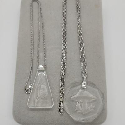 Lot J35: Plexiglass etched Owl, and, a glass etched Mushroom necklace.