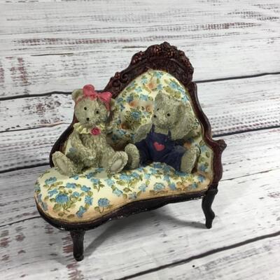 Floral antique couch with two bears figurines