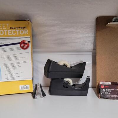 Lot 553: Office / School Supplies Bundle - Tape Dispensers, Protectors, Staple Puller and Clipboard