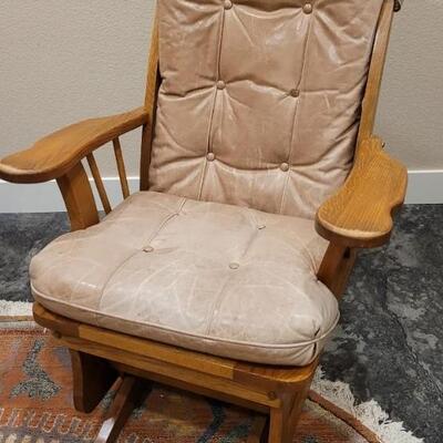 Lot 589: Leather Glider (missing button but we have it so it can be repaired)
