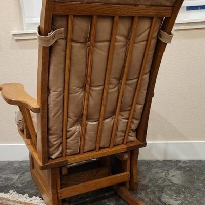 Lot 589: Leather Glider (missing button but we have it so it can be repaired)