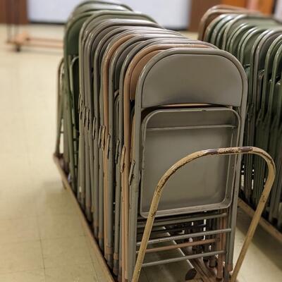 About 25 Metal Folding Chairs with handle cart
