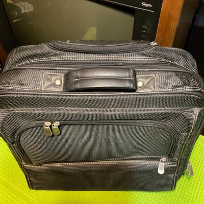 Carry-on travel bag with handles and wheels