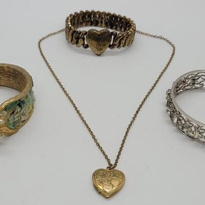 Lot J71: Hinged bangle bracelet with sea glass, rhinestone cuff bracelet, sweetheart stretch bracelet and locket on 16