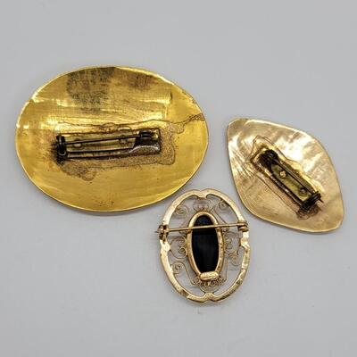 Lot 95: 3 gold fill pendants one is signed Catamore and has a black onyx center