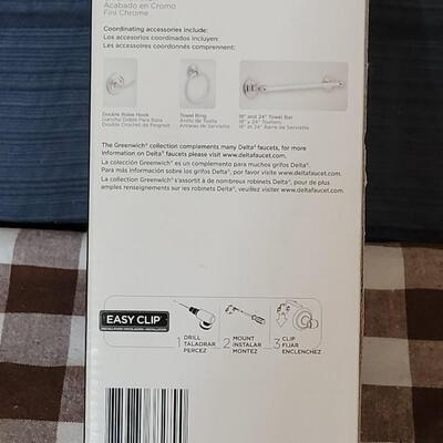 Lot 108: New in Package Delta Toliet Paper Holder with Chrome Finish