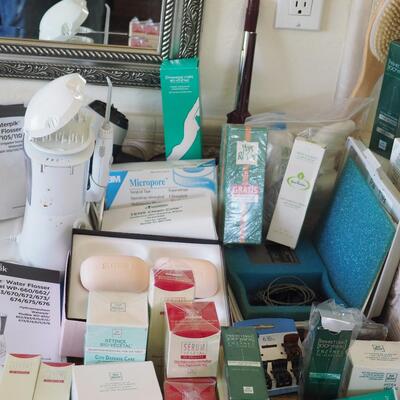 Lot 85 New cosmetics used waterpik and other toiletry supplies