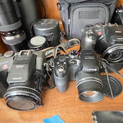 Lot 94 Huge lot of film and digital cameras, manuals, lens, cases, Binoculars, book