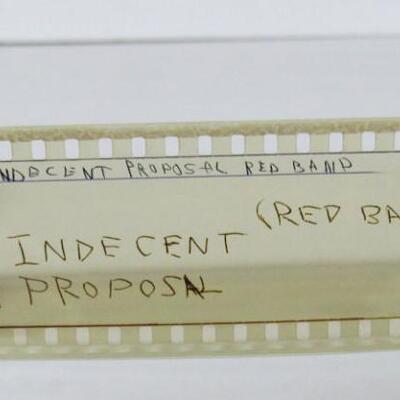 35 mm Film Reels, 1 Appears to be Basketball, 1 Is Indecent Proposal Trailer, 1 is USAF Wedding Only Just Begun, 1 Unknown