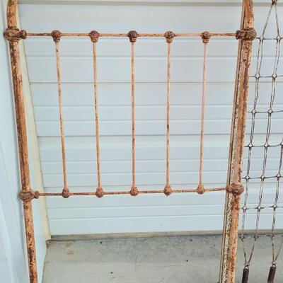 Lot 207: Antique Metal Baby Bed (has aged chippy pink paint- deco only)