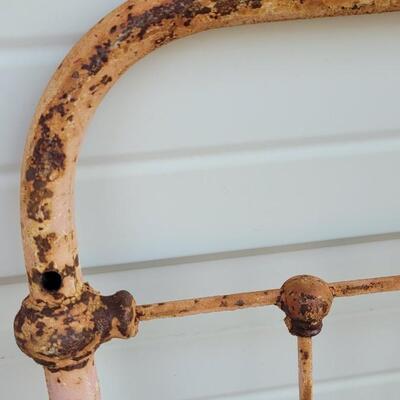 Lot 207: Antique Metal Baby Bed (has aged chippy pink paint- deco only)