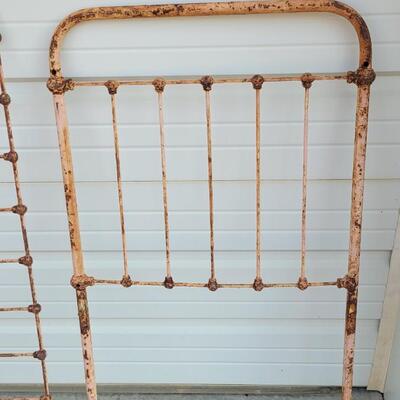 Lot 207: Antique Metal Baby Bed (has aged chippy pink paint- deco only)