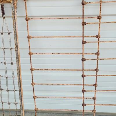 Lot 207: Antique Metal Baby Bed (has aged chippy pink paint- deco only)