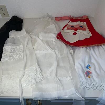 Lot 221  Six Vintage Aprons