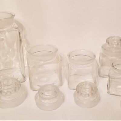 Lot #102  Set of Clear Glass Canisters - Ground glass tops