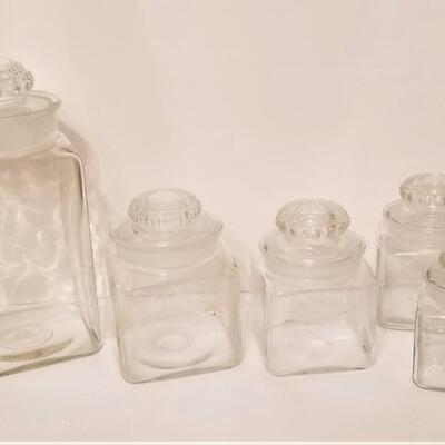 Lot #102  Set of Clear Glass Canisters - Ground glass tops