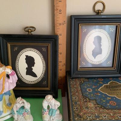 Lot 036: Whitman Vintage Cloisonne Tin, Framed Silhouettes, Figural Porcelain Lamp & More