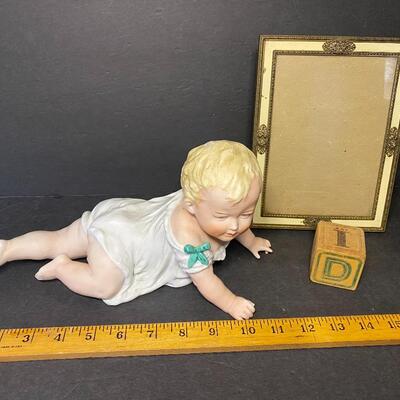 Lot 013:  Vintage Porcelain Figural Piano Baby & Vintage Picture Frame