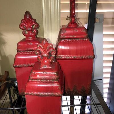 3 red storage canisters with fleur de lis