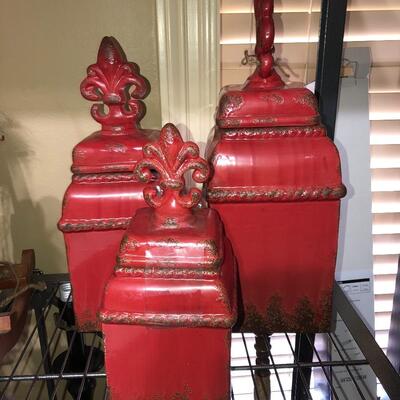 3 red storage canisters with fleur de lis