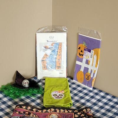 Lot 284: Halloween Table Runners, Dia de los Muertos Towel,Plastic Tablecloth and Hat 