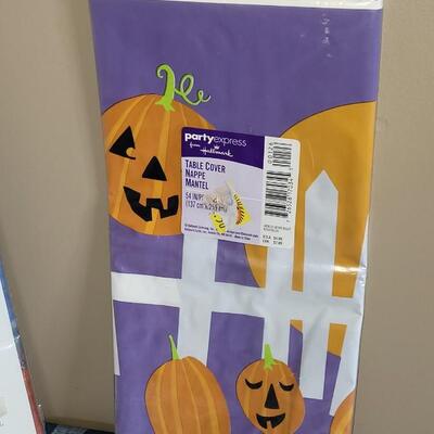 Lot 284: Halloween Table Runners, Dia de los Muertos Towel,Plastic Tablecloth and Hat 