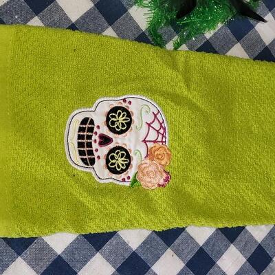 Lot 284: Halloween Table Runners, Dia de los Muertos Towel,Plastic Tablecloth and Hat 