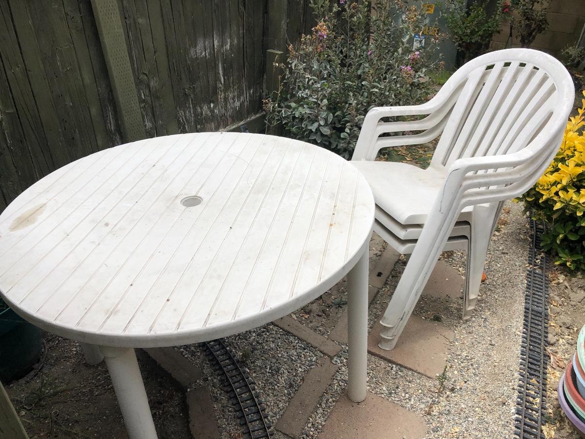 White Plastic Patio Table and Three Chairs
