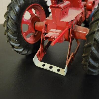 Lot 102: Vintage Cast Iron FARMALL 460 Toy Tractor