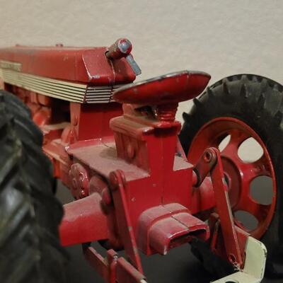 Lot 102: Vintage Cast Iron FARMALL 460 Toy Tractor