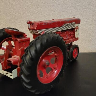Lot 102: Vintage Cast Iron FARMALL 460 Toy Tractor