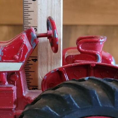 Lot 105: Vintage Cast Iron Farmall Red Tractor
