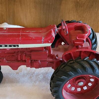 Lot 105: Vintage Cast Iron Farmall Red Tractor