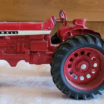 Lot 105: Vintage Cast Iron Farmall Red Tractor