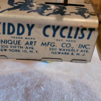 Lot 132: 1930's Kiddy Cyclist Wind Up Tin Toy by Unique Art Mfg. Co. (works)