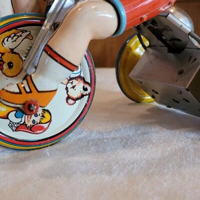 Lot 132: 1930's Kiddy Cyclist Wind Up Tin Toy by Unique Art Mfg. Co. (works)