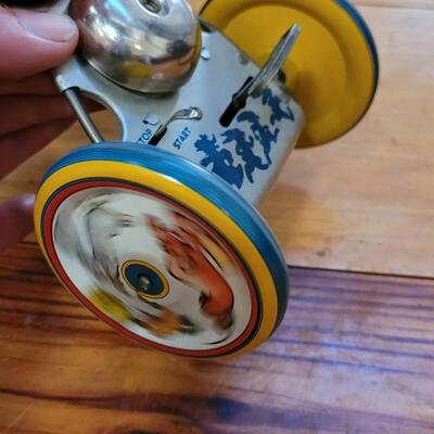 Lot 132: 1930's Kiddy Cyclist Wind Up Tin Toy by Unique Art Mfg. Co. (works)
