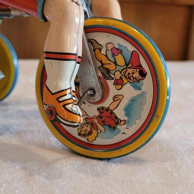 Lot 132: 1930's Kiddy Cyclist Wind Up Tin Toy by Unique Art Mfg. Co. (works)