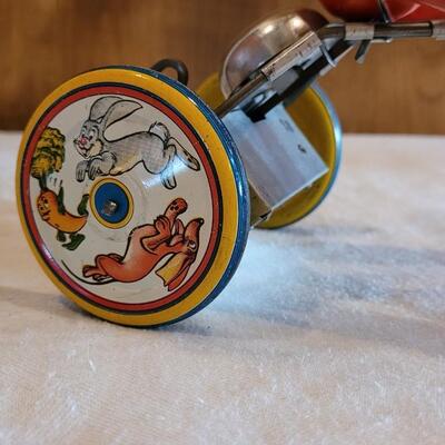 Lot 132: 1930's Kiddy Cyclist Wind Up Tin Toy by Unique Art Mfg. Co. (works)