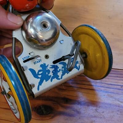Lot 132: 1930's Kiddy Cyclist Wind Up Tin Toy by Unique Art Mfg. Co. (works)