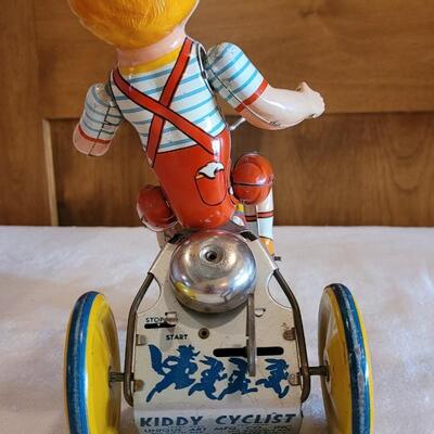 Lot 132: 1930's Kiddy Cyclist Wind Up Tin Toy by Unique Art Mfg. Co. (works)