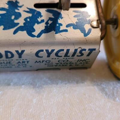 Lot 132: 1930's Kiddy Cyclist Wind Up Tin Toy by Unique Art Mfg. Co. (works)