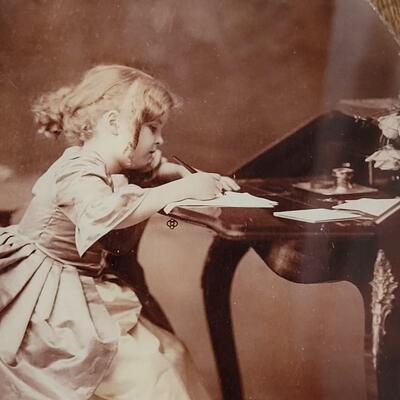 Lot 261: Antique Framed Picture of Girl at Secretary