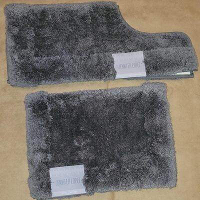 Lot 298: Jennifer Lopez Dark Gray Bathroom Contour Rug and 17" Ã— 24" Rug