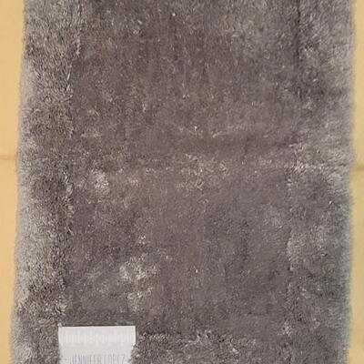 Lot 298: Jennifer Lopez Dark Gray Bathroom Contour Rug and 17" Ã— 24" Rug
