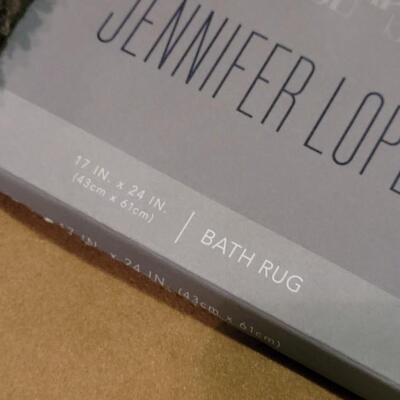 Lot 298: Jennifer Lopez Dark Gray Bathroom Contour Rug and 17" Ã— 24" Rug